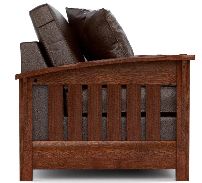 A wooden armchair with dark brown leather cushions, shown from a three-quarter angle against a white background.