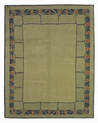 Green area rug with decorative border on a white background