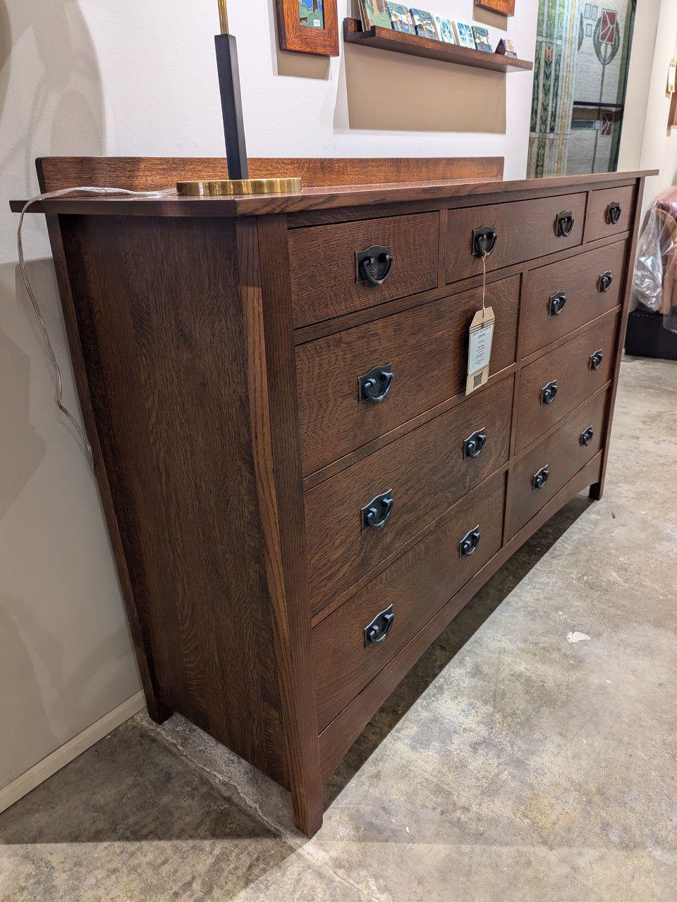 Wooden dresser with multiple drawers in a room setting. Harvey Ellis Master Dresser by Stickley