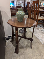 Wooden tea table by Stickley with a green vase on top in an indoor setting.