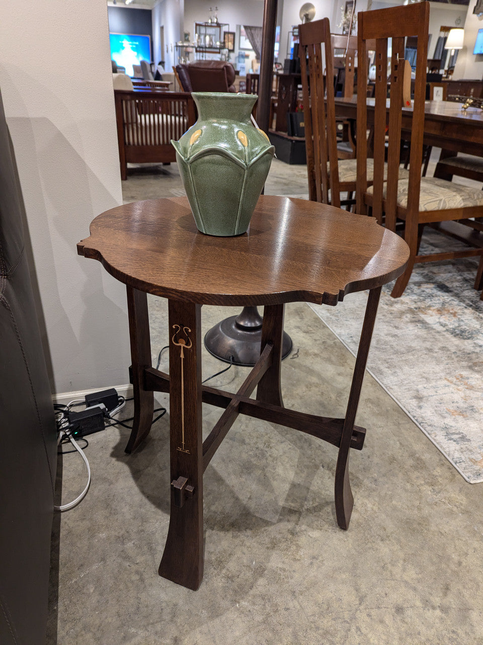 Wooden tea table by Stickley with a green vase on top in an indoor setting.