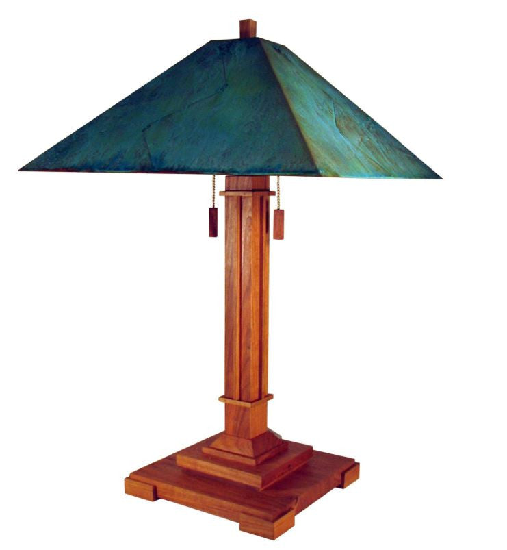 Wooden table lamp with a green lampshade on a white background