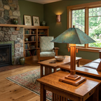 A rustic living room featuring a prominent table lamp with a distressed teal-green metal shade and a warm wood base, set on a wooden table in a cozy room with a stone fireplace, bookshelves, and a patterned armchair.