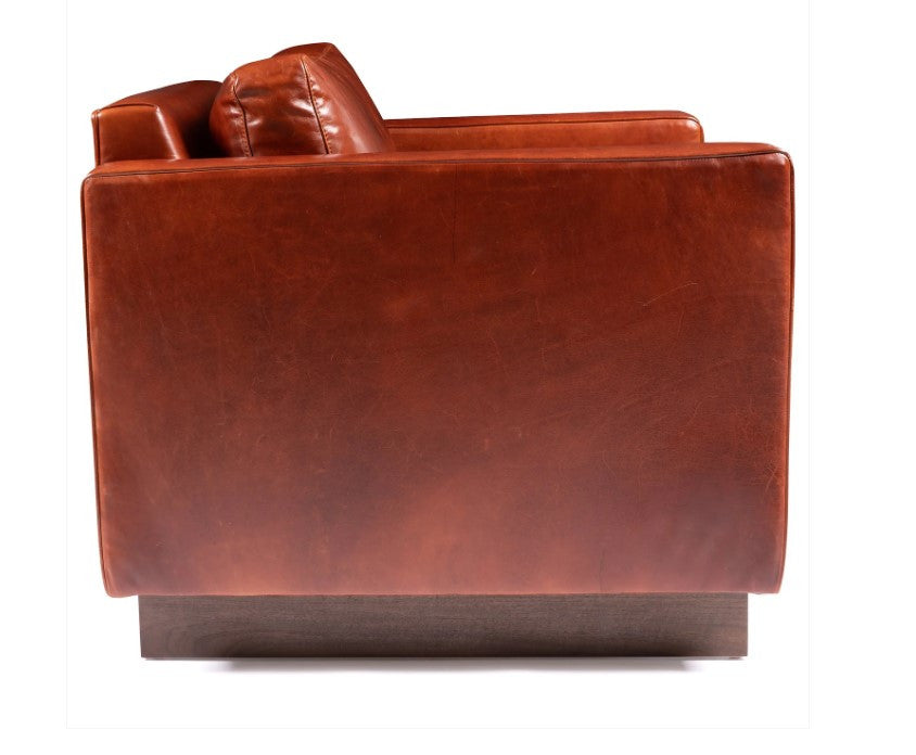 Brown leather armchair on a white background