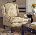 Patterned armchair in a living room setting with a coffee table and flowers.