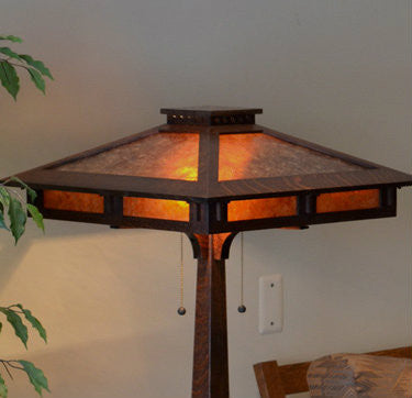 Decorative outdoor lamp with a warm glow on a neutral background