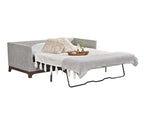Sleeper sofa opened with mattress and bed sheets. 