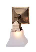 Brass wall sconce with a white glass shade on a white background