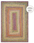 A rectangular braided area rug with concentric rectangular patterns, featuring a multicolor mix of yellow, green, blue, pink, and red yarns. A white circular badge in the top right corner reads 'SAMPLE THE COLORS ORDER A SWATCH'.