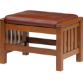 Wooden stool with a brown leather seat on a white background