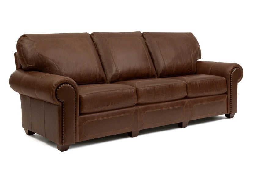 A three-seater brown leather sofa with rolled arms, button tufting, and nailhead trim, shown on a plain white background.