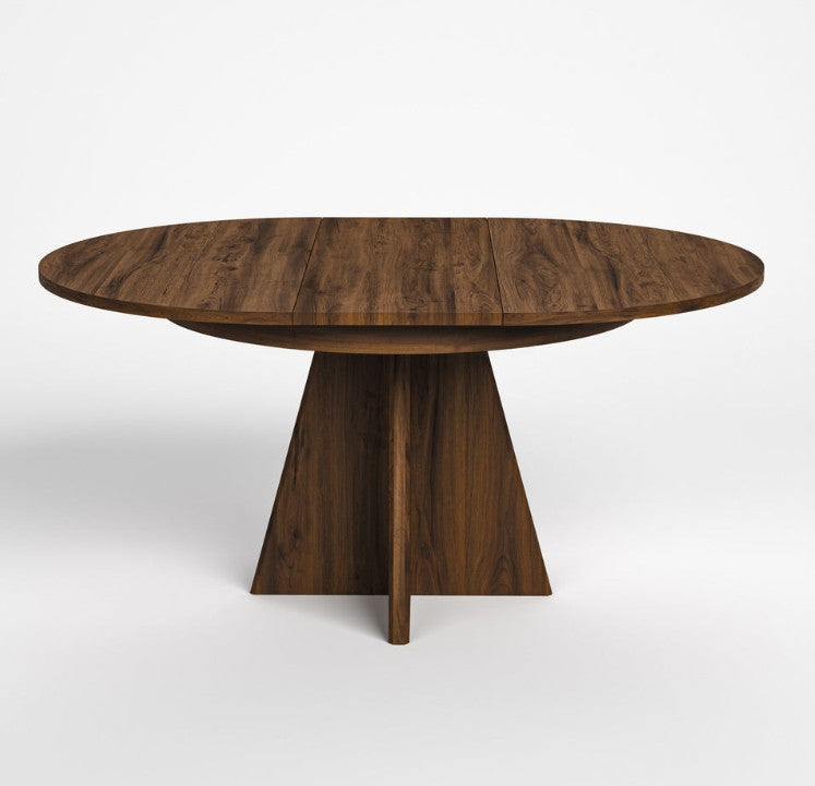 A dark brown wooden dining table with a round top and a sculptural, multi-pronged pedestal base, shown on a light gray background.