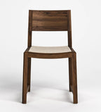 A modern wooden dining chair with a dark brown wood frame and a light beige woven seat, shown against a plain white studio background.