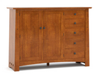 A warm medium-brown wooden sideboard cabinet with two paneled doors and four drawers on the right, featuring small dark metal knobs and decorative corner brackets, shown on a white background.
