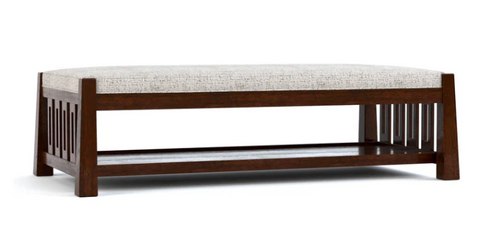 A ottoman and cocktail table with a dark brown frame, featuring a light beige textured upholstered seat cushion and a lower open shelf, shown against a plain white background.