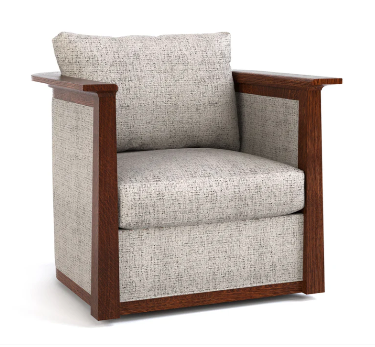A modern armchair with a warm brown wooden frame and textured light beige fabric upholstery, shown on a plain white background.