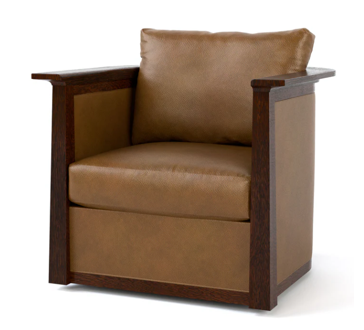 A modern armchair with a warm brown leather seat and back cushion, framed by dark brown wood arms and sides, shown on a plain white background.