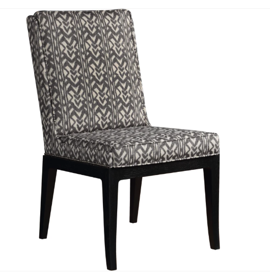 An upholstered dining chair with a black and gray geometric patterned fabric on the seat and backrest, supported by slim black legs, shown against a plain white background.