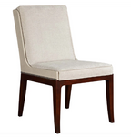 An upholstered dining chair with a high back, light beige textured fabric seat and backrest, and dark brown wooden legs with a silver nailhead trim, shown on a plain white background.