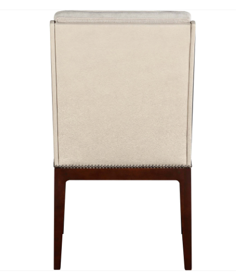 A high-back dining chair with a textured beige upholstered backrest and dark brown wooden legs, featuring silver nailhead trim at the base.