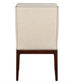 A high-back dining chair with a textured beige upholstered backrest and dark brown wooden legs, featuring silver nailhead trim at the base.