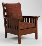 A classic wooden armchair with a dark brown wood frame and red patterned fabric cushions on the seat and backrest, shown against a neutral light gray background.