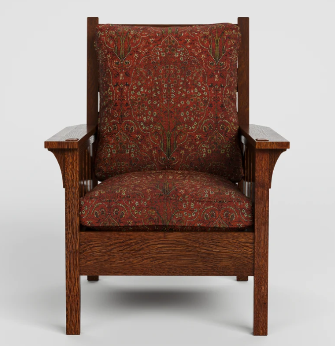 A classic armchair with a dark reddish-brown wooden frame and plush seat and back cushions upholstered in a red and green botanical patterned fabric, shown against a neutral light gray background.