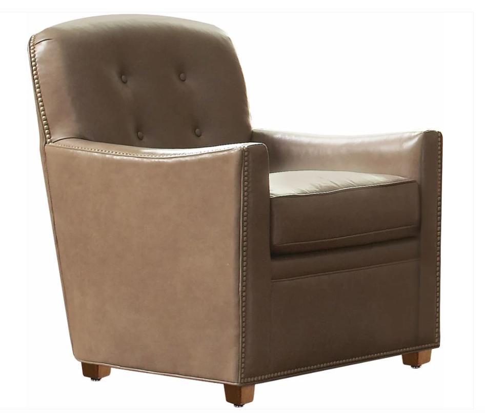 A classic brown leather club chair with button tufting on the backrest, nailhead trim along the edges, and small wooden feet, shown against a plain white background.