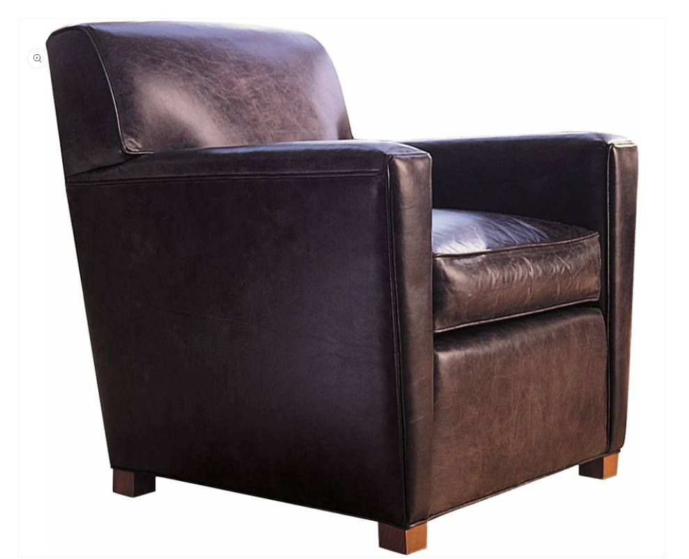 A dark brown leather armchair with a high back, wide armrests, and small wooden feet, shown against a plain white background.