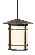 A hanging pendant light fixture with a dark textured metal frame and a warm cream-colored cylindrical shade, suspended by a dark rod against a plain white background.