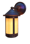 A rustic outdoor wall sconce with a dark bronze-finished metal frame and a warm yellow-orange glowing light inside a ribbed glass shade, mounted on a matching backplate.