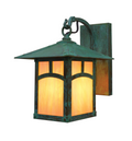 A square outdoor wall sconce with a dark green patina finish and warm orange glowing glass panels, shown against a plain white background.