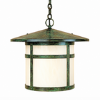 A hanging outdoor lantern light with a distressed green and bronze metal frame and a cream-colored glass shade, suspended by a chain against a plain white background.
