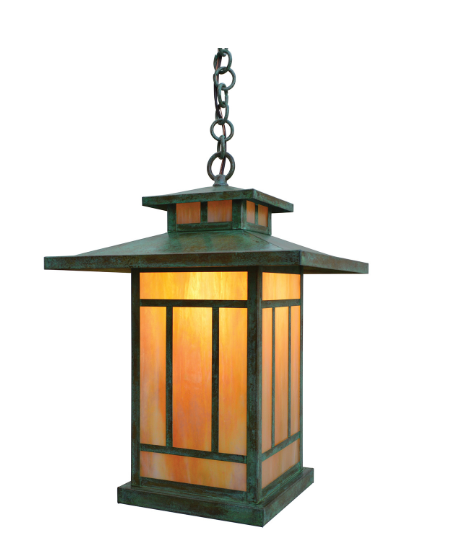 A hanging lantern-style outdoor light fixture with a dark green weathered metal frame and warm amber-orange glass panels, suspended by a chain against a plain white background.