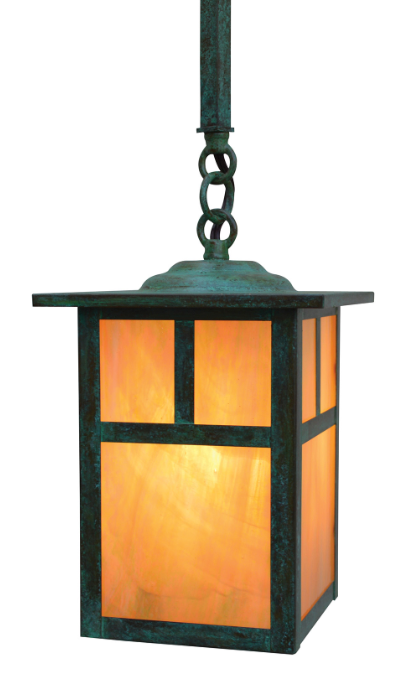 A hanging lantern-style light fixture with a dark green patina metal frame and warm orange glowing glass panels, shown against a plain white background.