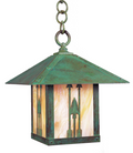 A hanging outdoor lantern with a weathered green metal frame and a warm amber-tinted glass front featuring three arrow motifs, suspended by a chain against a white background.