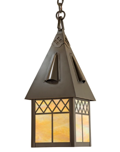 A hanging metal lantern with a pointed roof and warm amber-tinted glass panels, shown against a plain white background.