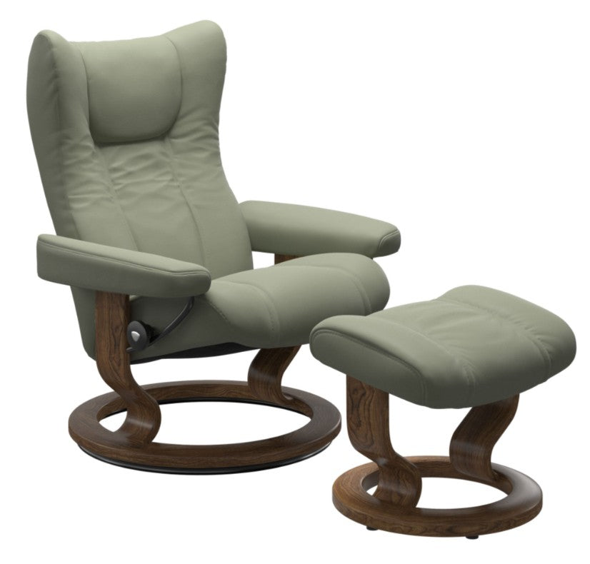 Green recliner chair with wooden base and matching ottoman on a white background