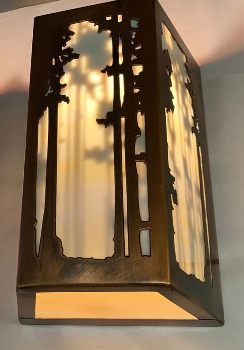 Decorative wall sconce with cut-out design on a neutral background