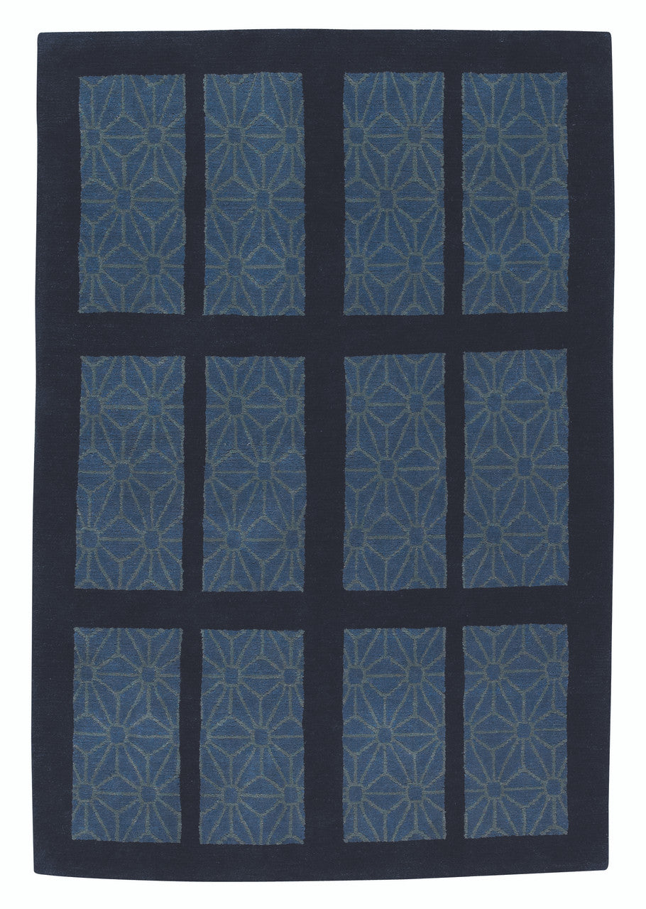 Blue geometric patterned rug on a black background