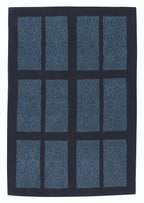 Blue geometric patterned rug on a black background
