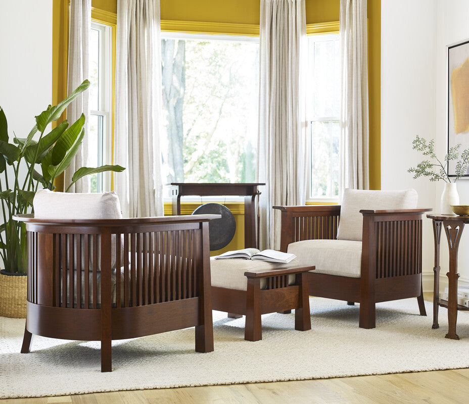 Wooden furniture set with white cushions in a room with yellow walls, large windows, and a gong