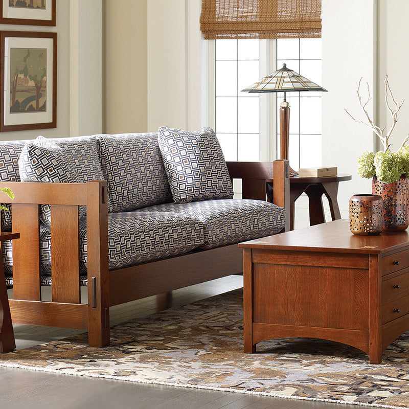 Living room with wooden sofa and coffee table, decorated with decorative items.