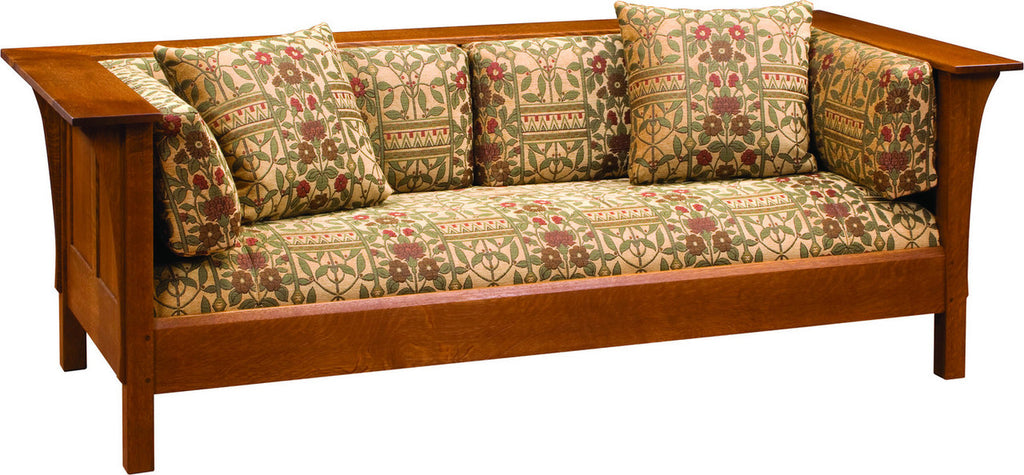 Wooden sofa with patterned cushions on a white background
