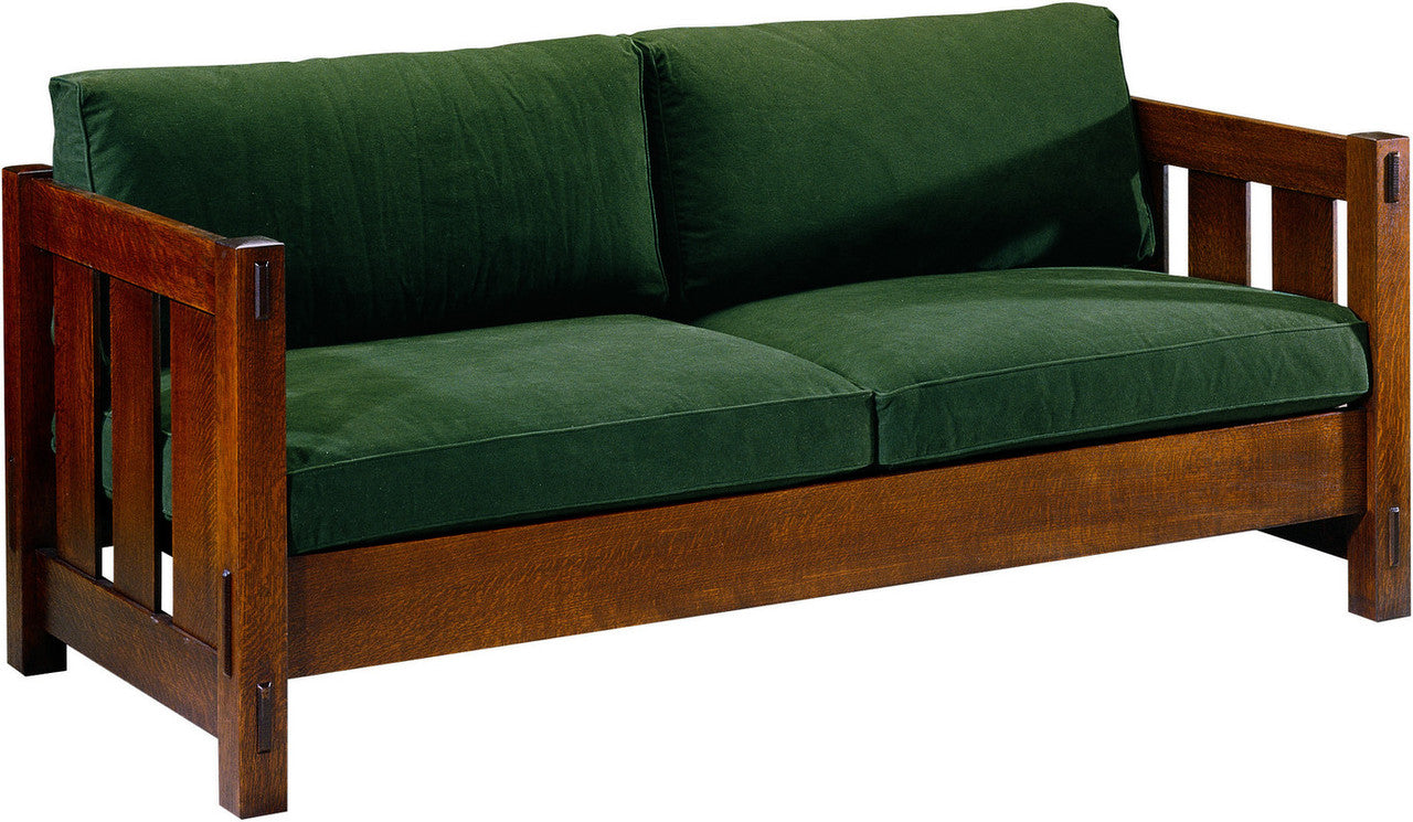 Wooden sofa with green cushions on a white background.