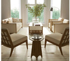 Modern living room with beige sofa, chairs, and coffee table near large windows.