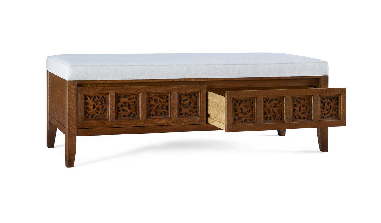 Wooden bench with white cushion and decorative carvings on a white background