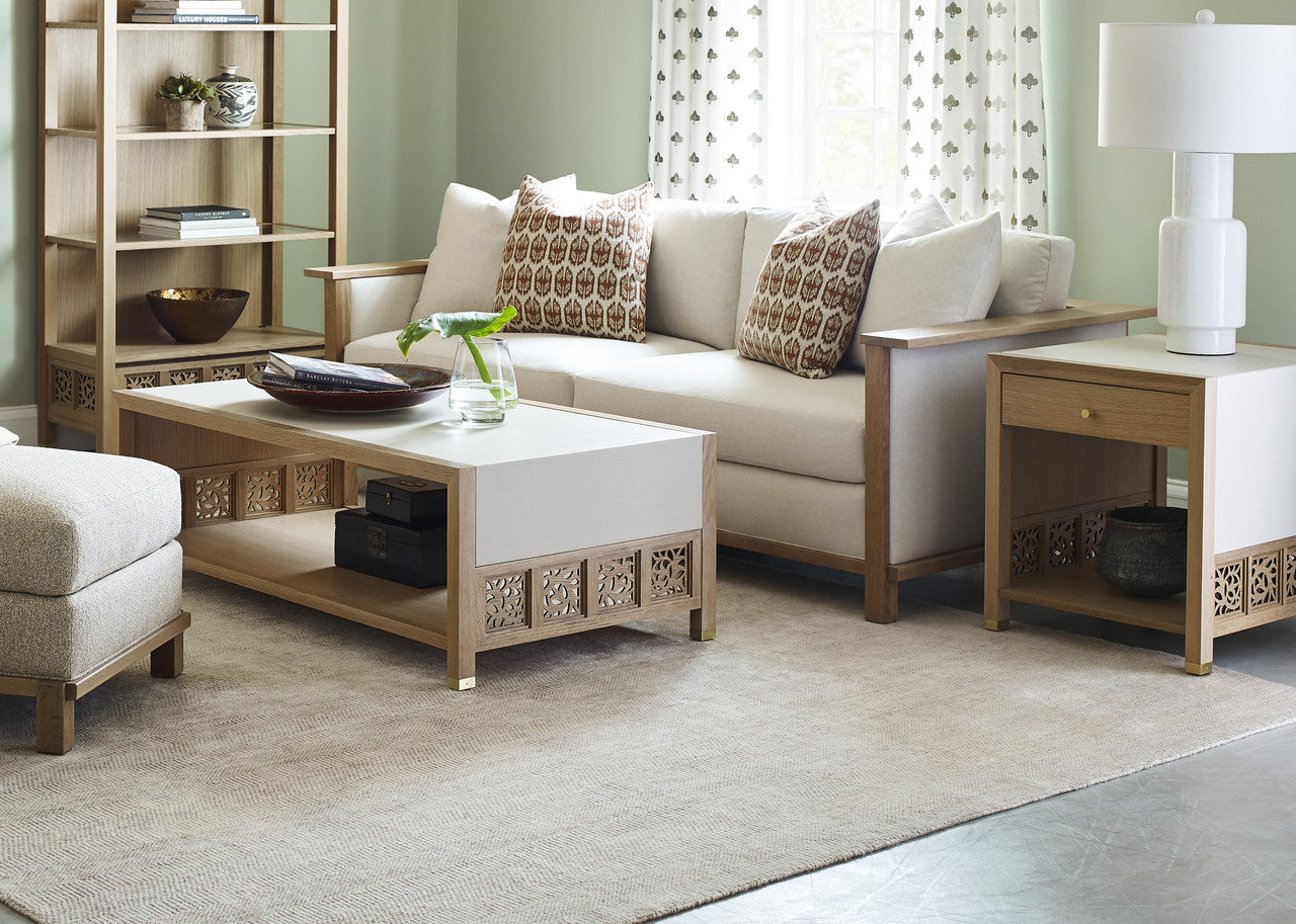 Living room with beige sofa, coffee table, and decorative pillows.