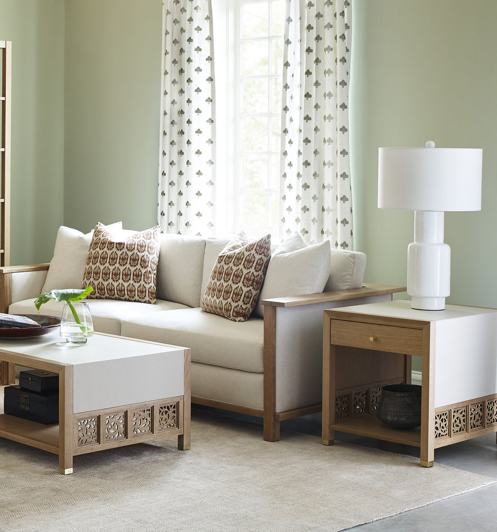Living room with beige sofa, coffee table, and side table with lamp.