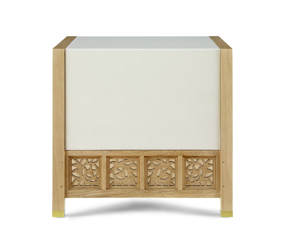 Wooden side table with decorative carvings on a white background
